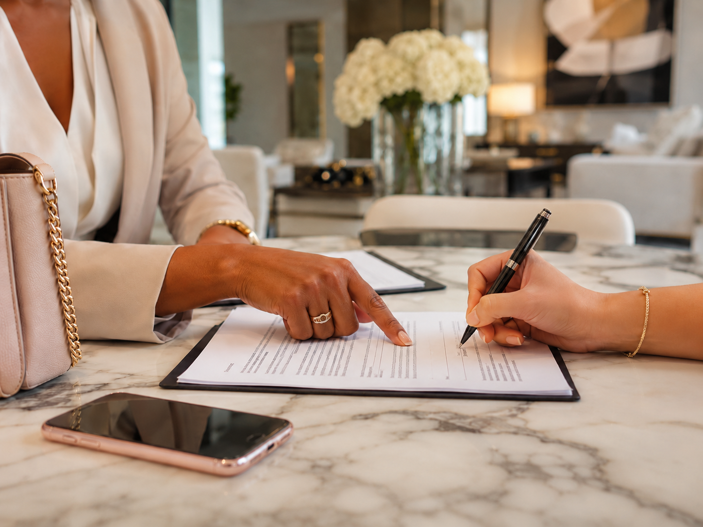 Signing paperwork with agent, phone on table
